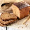 a loaf of Borodinskiy Rye Bread with wheat ears on a white surface