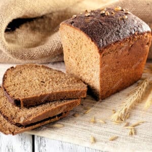 a loaf of Borodinskiy Rye Bread with wheat ears on a white surface