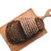 a sliced dark rye bread on a cutting board