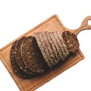 a sliced dark rye bread on a cutting board